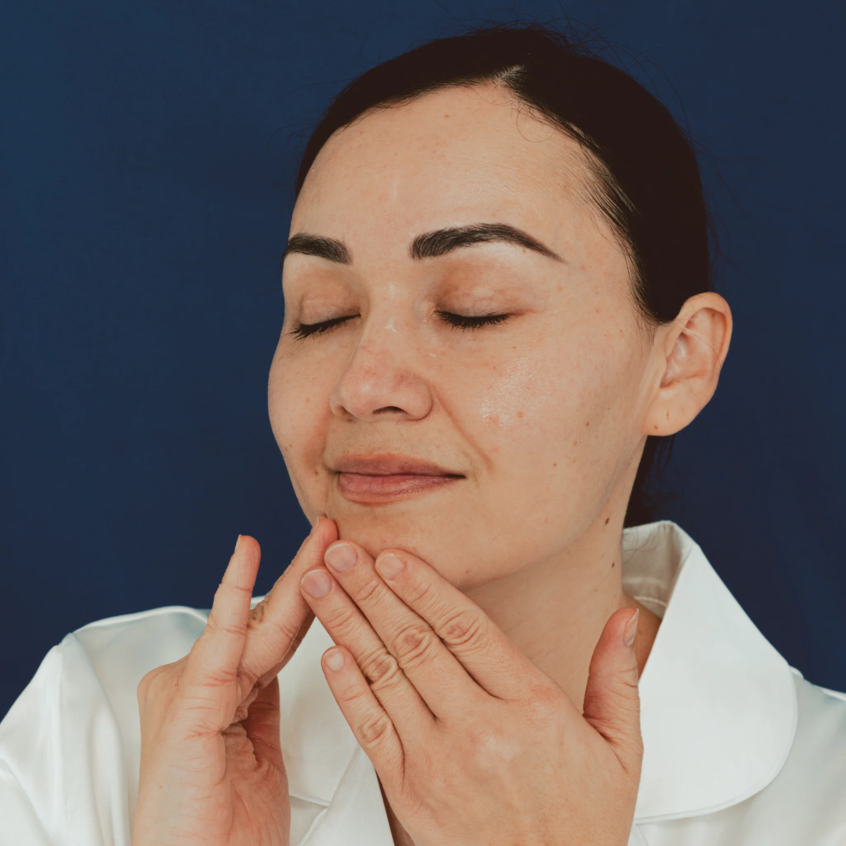 Dermasensa FS Facial Firming Serum, 30mL being applied along the jawline and chin