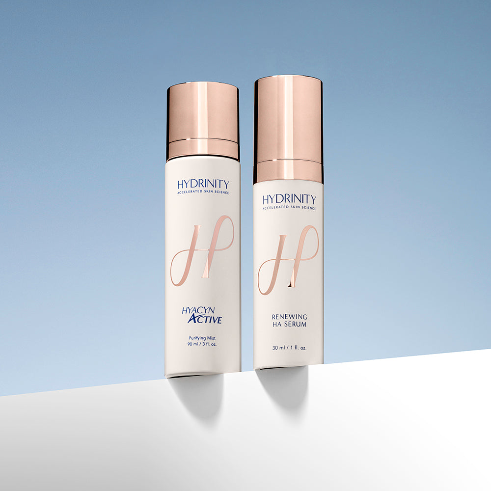 Two skincare bottles labeled 'Hydrinity' on a gradient blue background