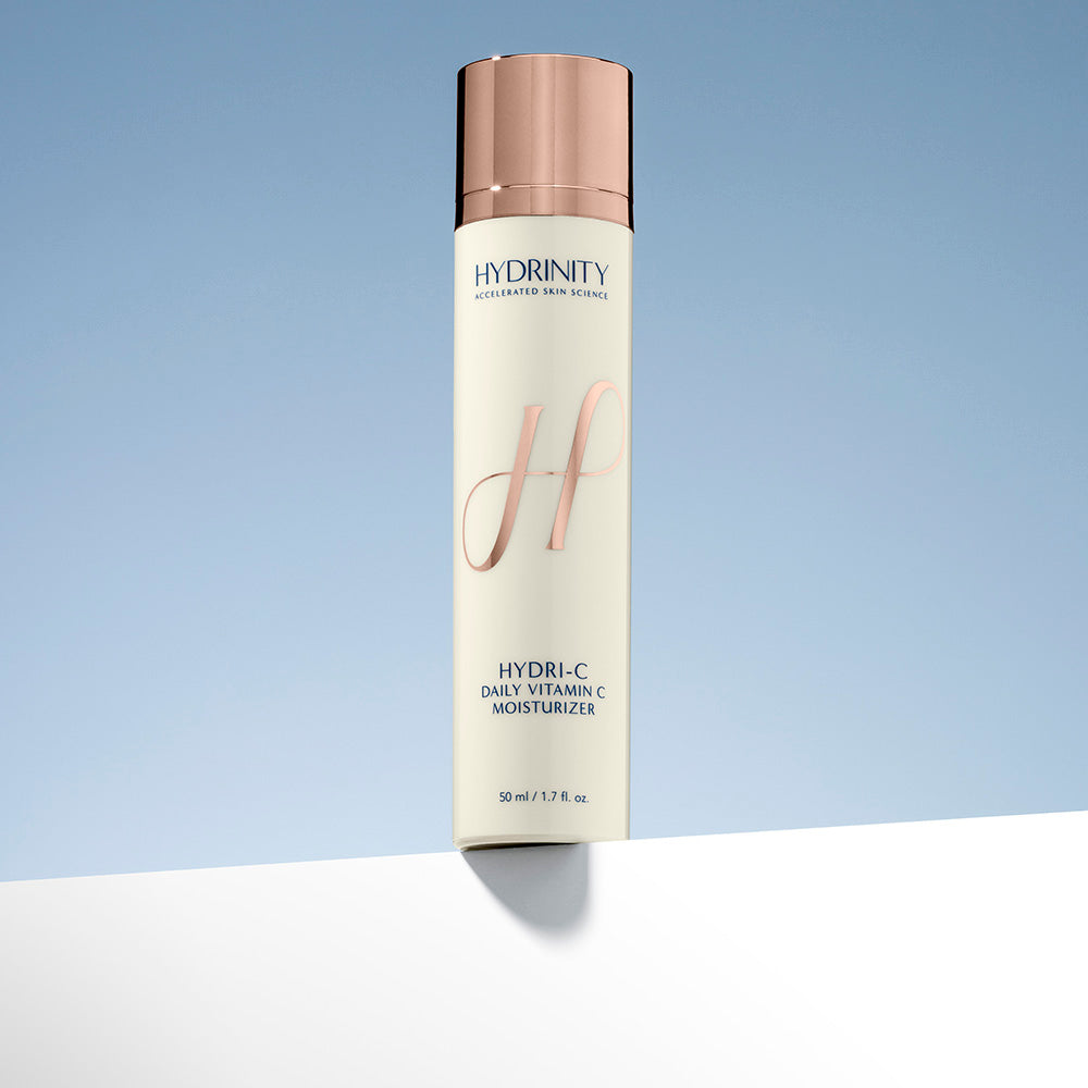 Hydrininity Hydri-C daily vitamin C moisturizer bottle on a light blue background