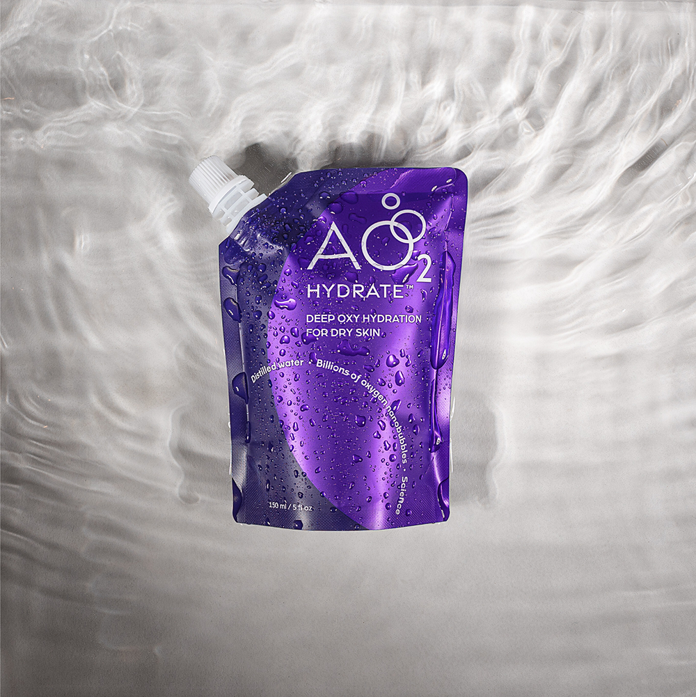 Purple skincare product packaging labeled 'AO2 Hydrate' on a textured white background