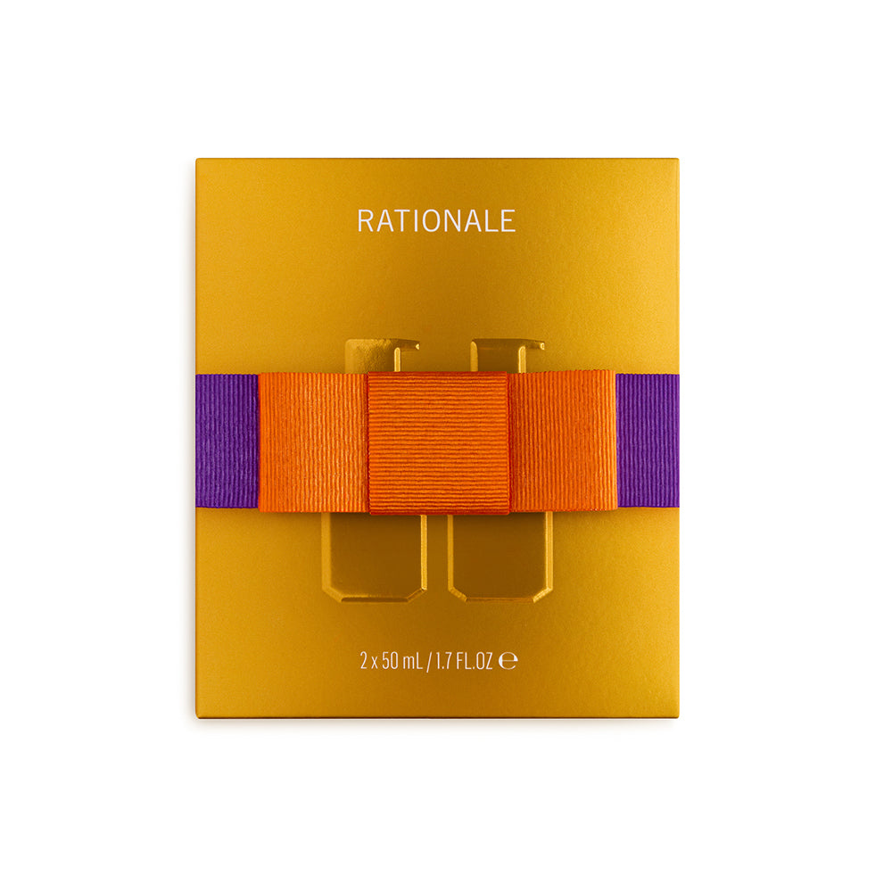Gold packaging with orange and purple ribbon by Rationale labeled The Strengthening Duo on white background
